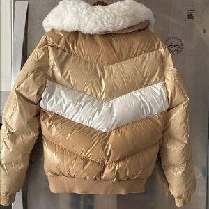 Tan Puffer Jacket with White Faux Fur Collar to show off your jeans